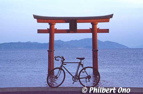 Shirahige Shrine torii in the lake and my bicycle at sunset.