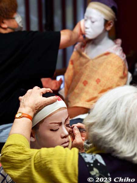 Putting on kabuki makeup on the boys.