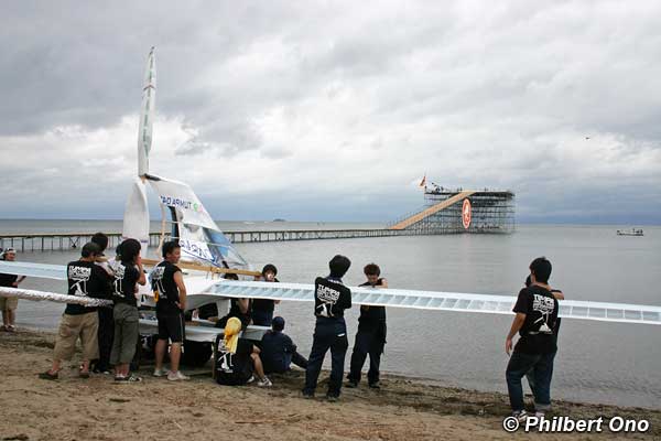 Planes are readied on the beach and carried up to the platform