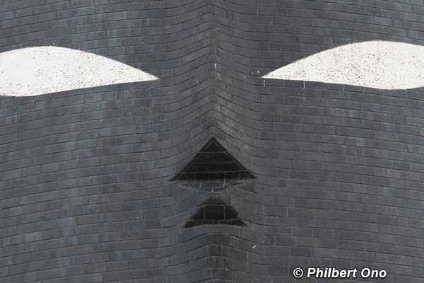 Tower of the Sun's black sun face painted on Shigaraki ceramic tiles.